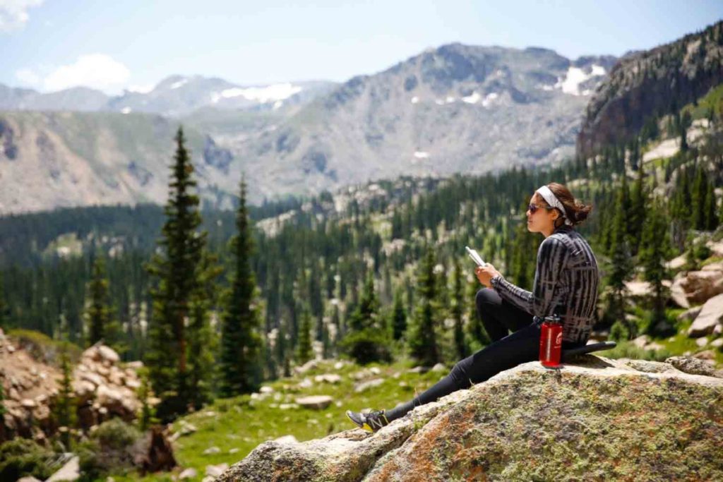 Summer Term girl reading on rock - edited